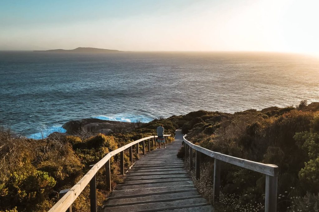 Wooden stairs leading down to the ocean at sunset near Albany, Western Australia—an iconic view from the Perth to Albany road trip.
