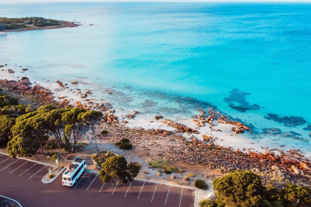 Aerial view of the Eagle Bay coastline near Dunsborough, with clear turquoise water, white sand and coastal bushland—an ideal scenic stop on a Perth to Albany road trip.